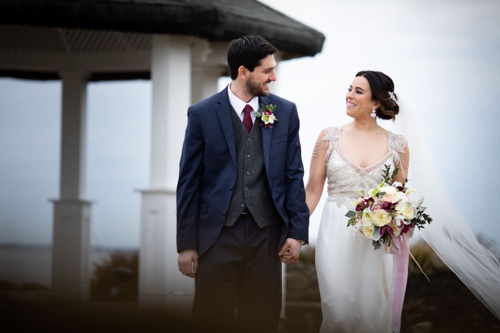 Romantic wedding portrait of couple sharing a tender moment against misty backdrop.