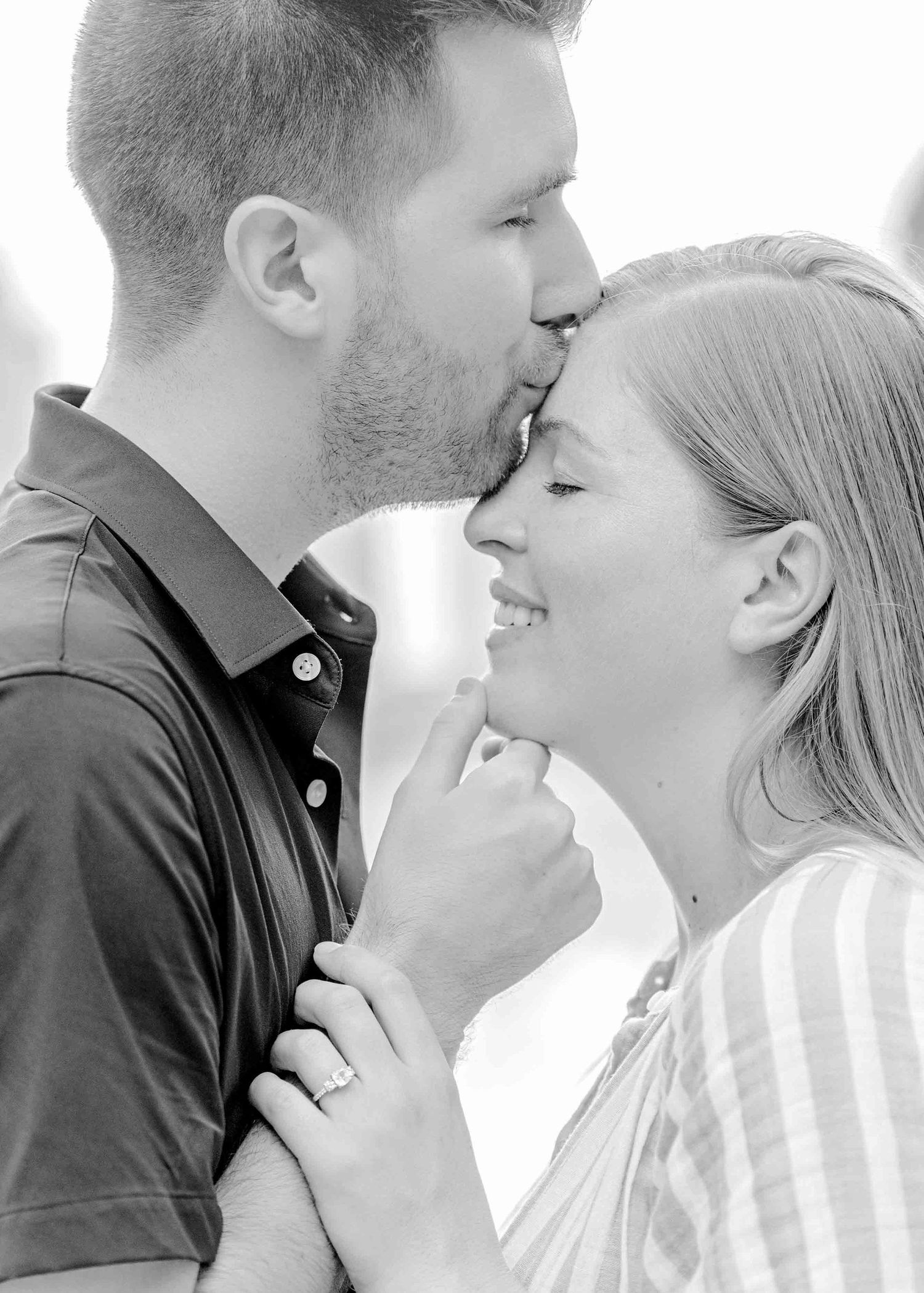 A romantic black and white portrait of a couple sharing an intimate moment together.
