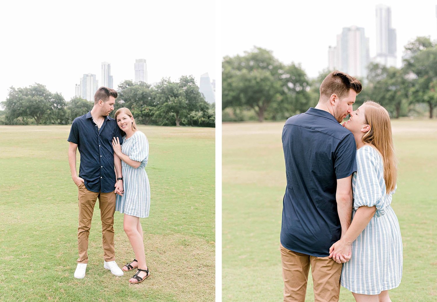 A couple embraces in a grassy field with a city skyline visible in the background.