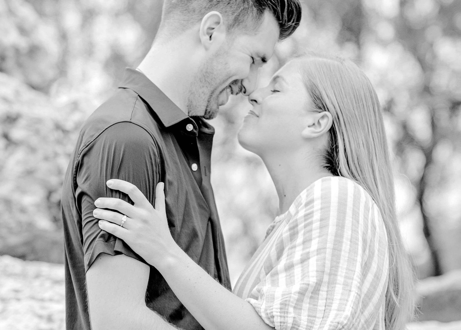Black and white romantic portrait of a couple sharing an intimate moment.