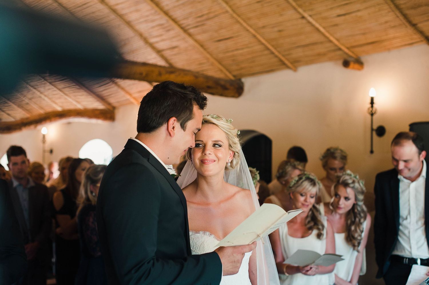 Bride smiling at the groom during their wedding ceremony