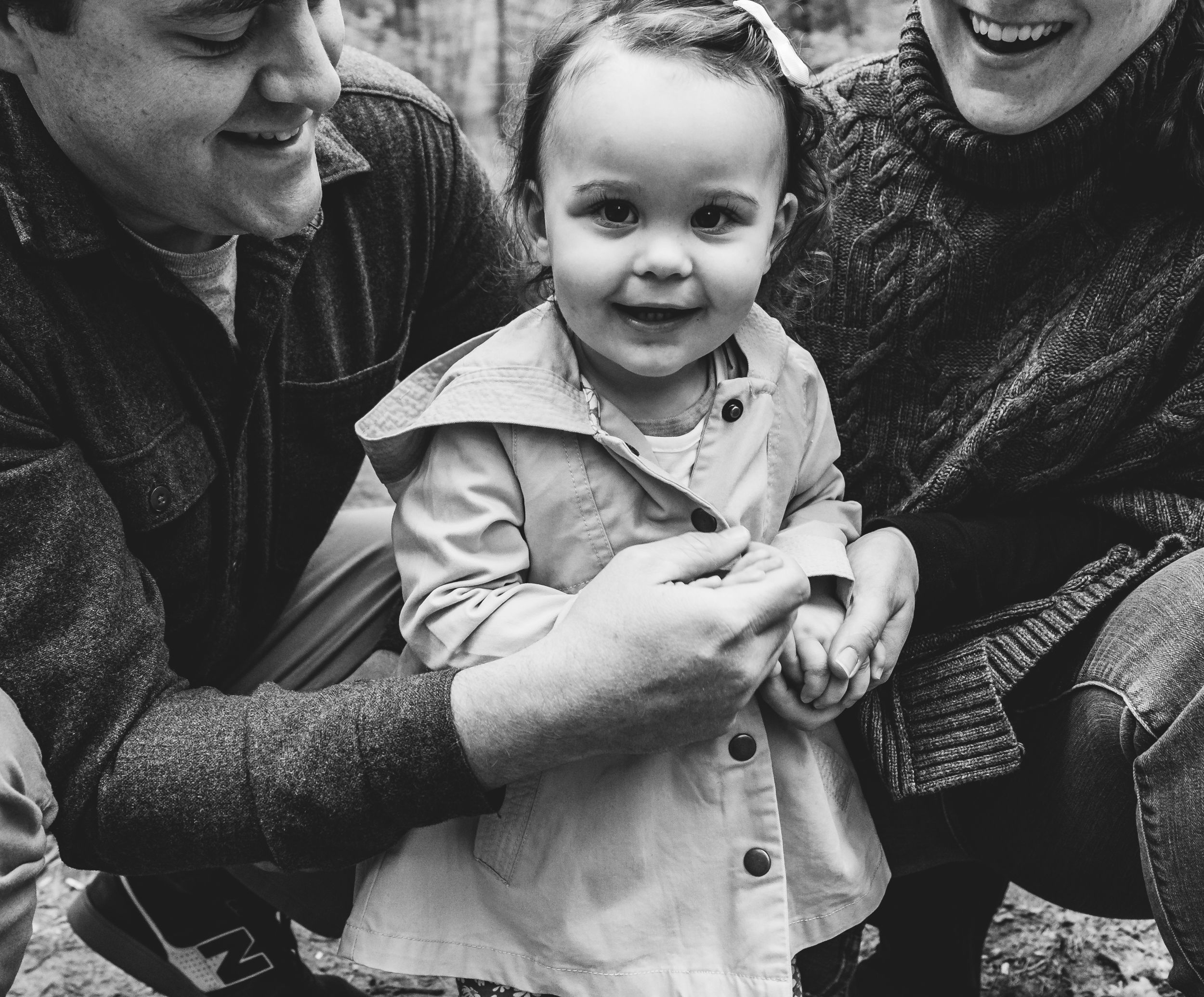 A family of three get in close for a portrait during a family session in Brunswick, Maine.