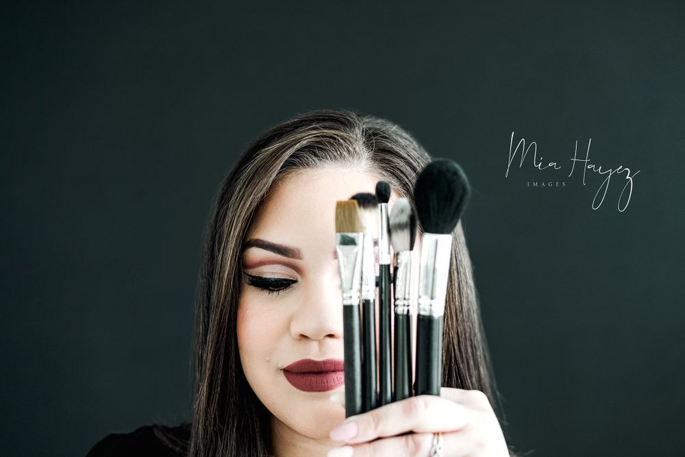 Close-up beauty shots with makeup brushes against a dark background.