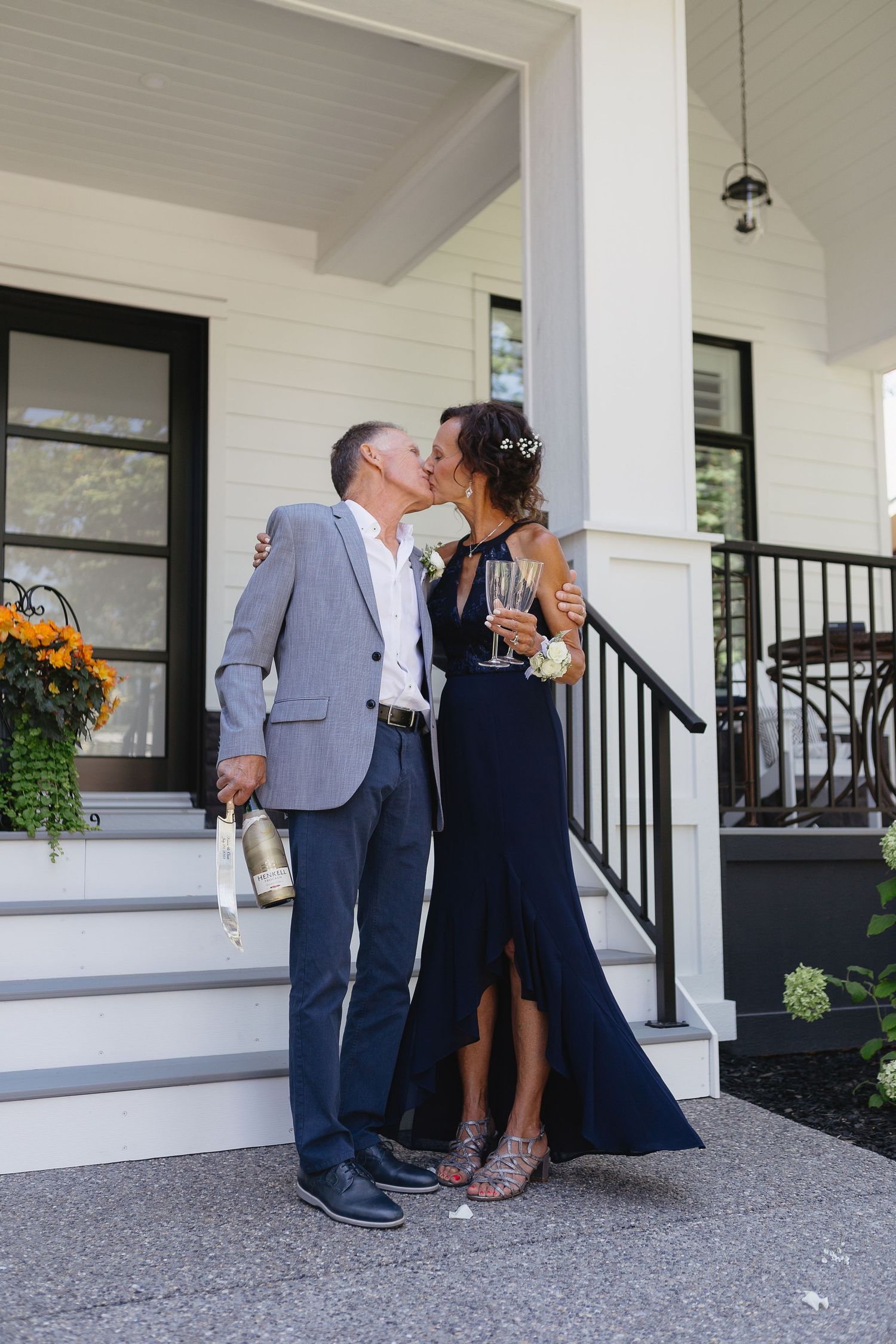 Romantic porch portraits in formal attire with navy dress and grey suit.