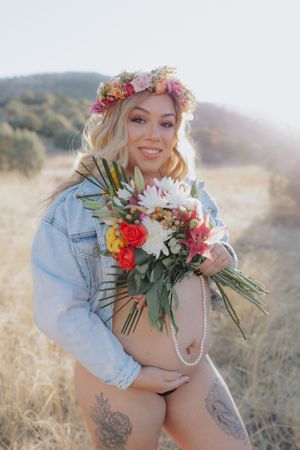 Artistic boudoir photography with floral elements and pearl accessories.