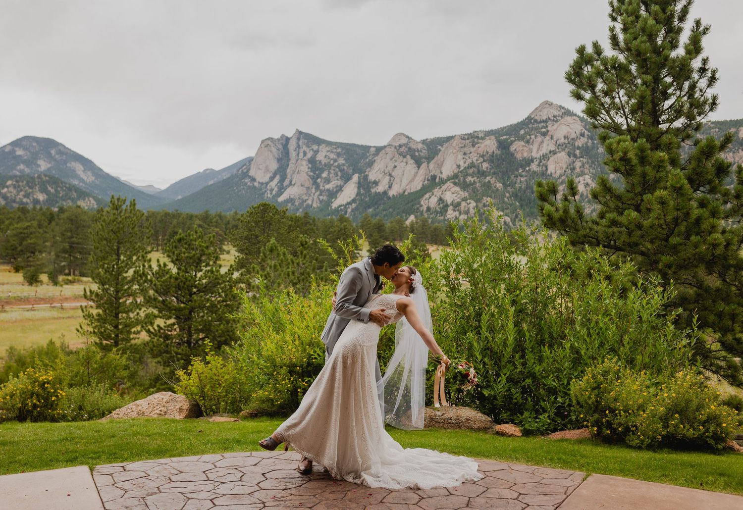 Majestic mountain backdrop with the newlyweds, framed by the natural beauty of Estes Park.