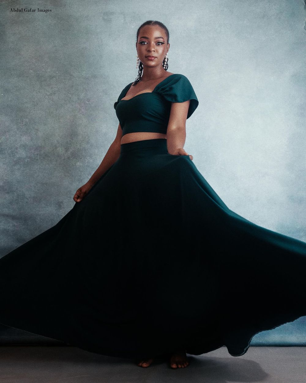 Portrait of a fashion designer showing off her beautiful two piece in all its glory.