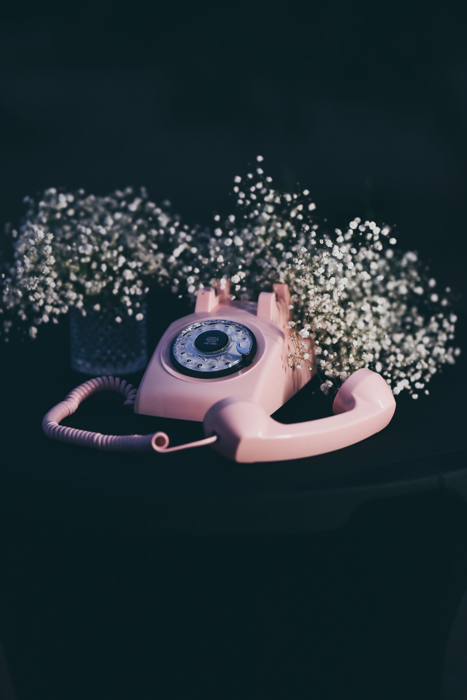 Pink Audio Guest Book Phone with white flowers on a dark background