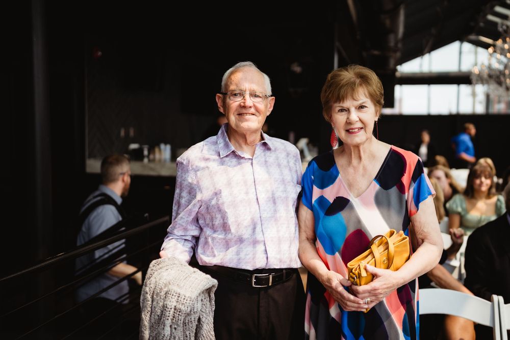 Wedding guests enjoying the celebration in an industrial-style venue.