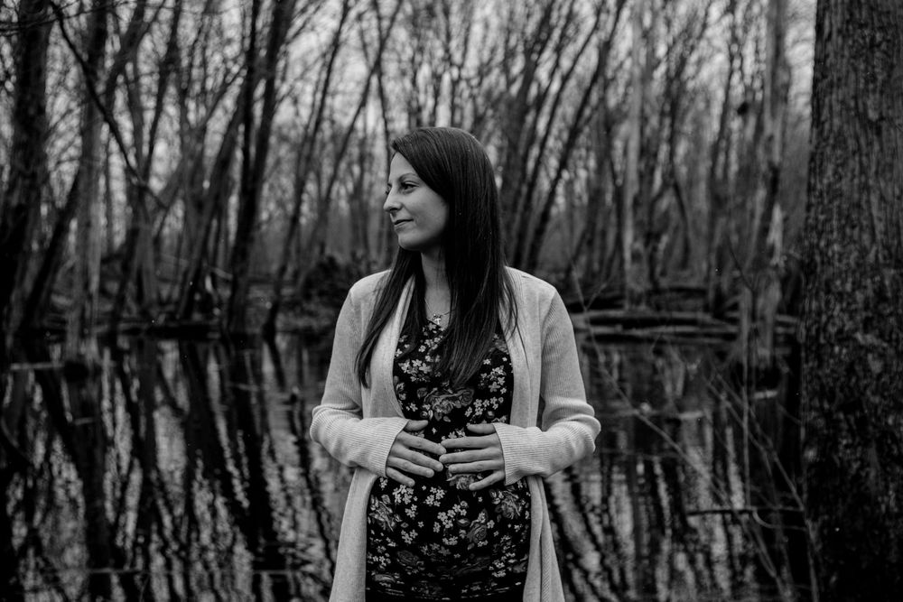 Winter couple photoshoot in black and white among bare trees.