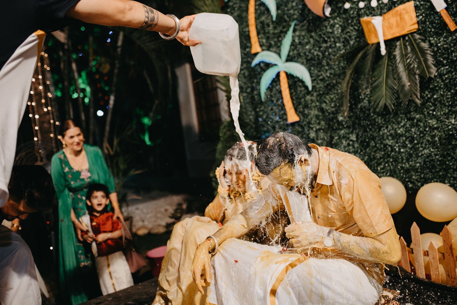 Candid moments of celebration captured during an evening outdoor wedding reception.