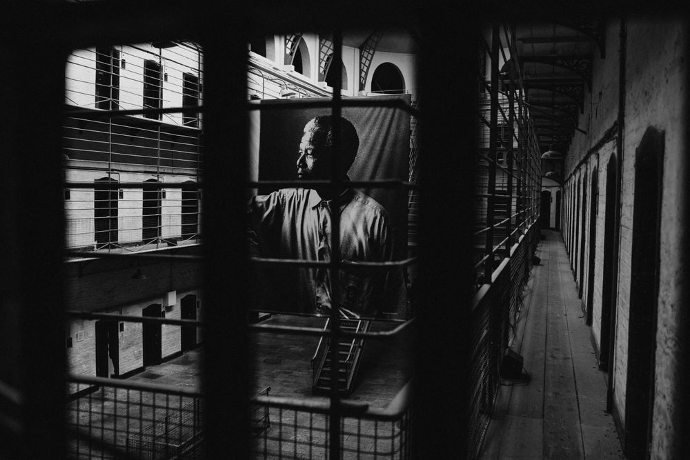 Dark urban alleyway with brick buildings and shadows creating a moody noir atmosphere.