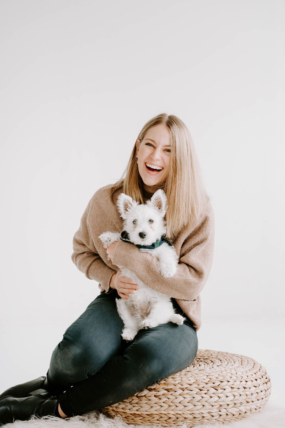 Playful moments with a small white dog on a woven mat against a bright white background.