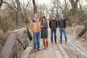 becky katzberg photography family photos in winter on a bridge with parents and two teenage boys