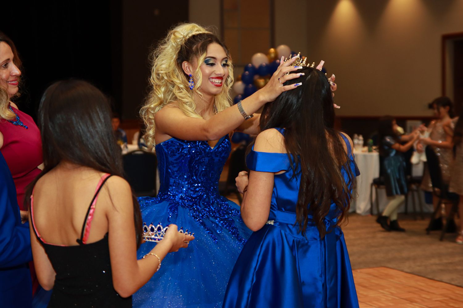 Quinceanera passing on the crown to sister
