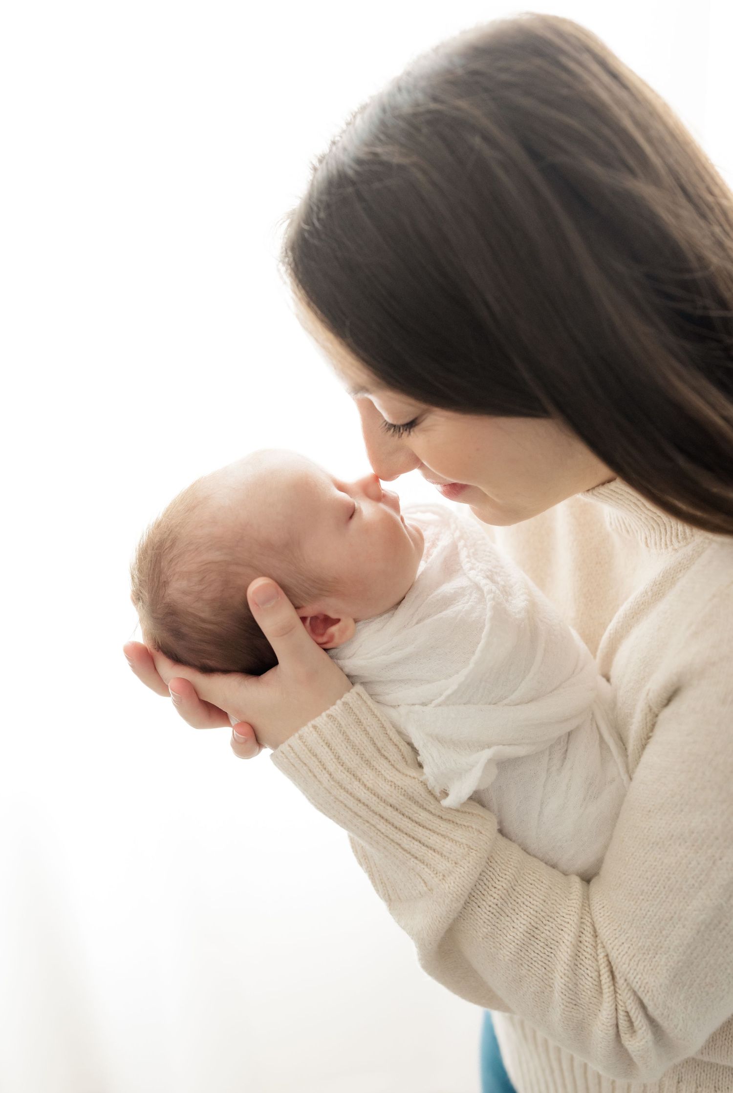 mom kissing baby