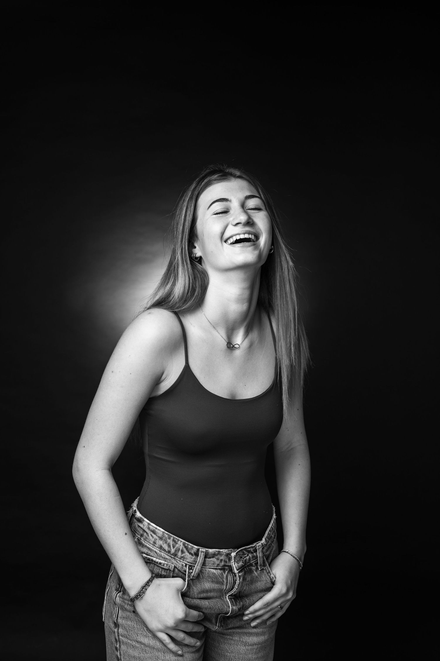 Black and white portrait capturing a joyful moment with natural, candid laughter.