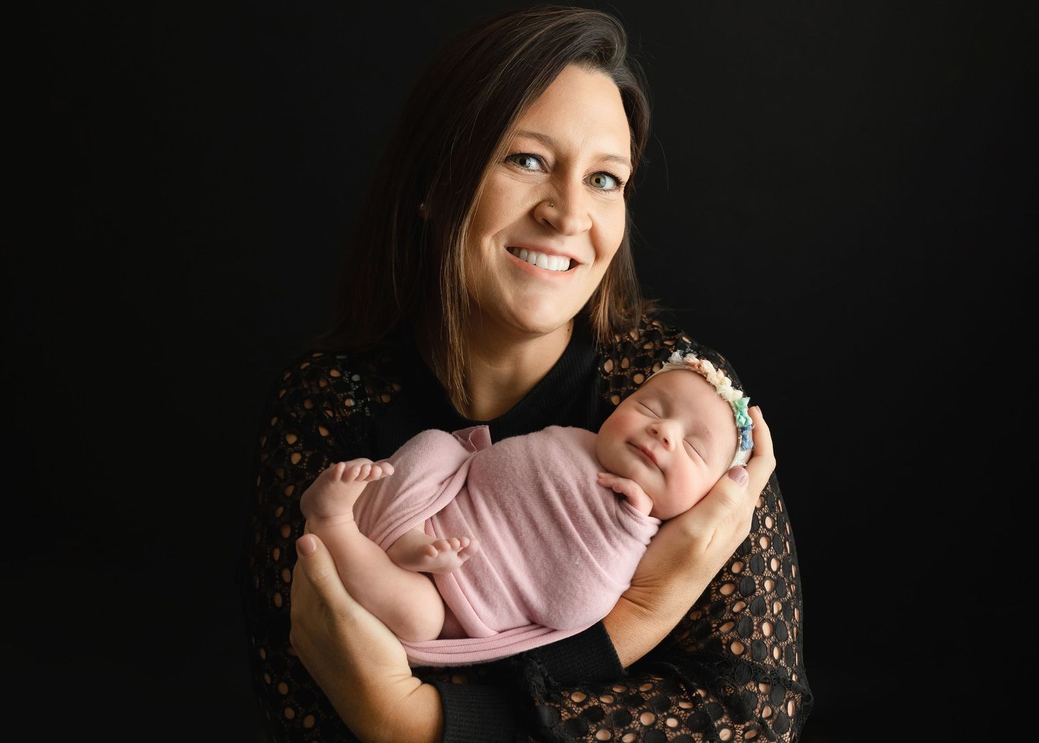 A mom holding and smiling while holding her newborn girl. Greenville SC newborn photographer, Easley, SC newborn photographer, Upstate SC ne