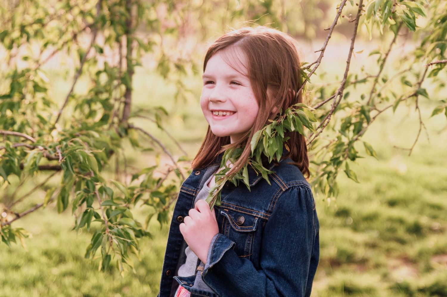 young girl smiling in tree