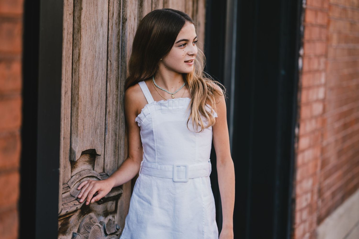 girl holding door