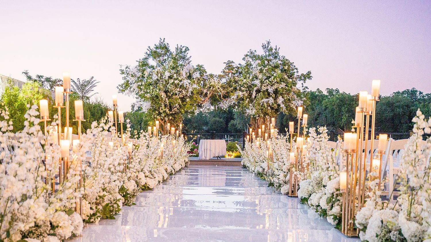 Outdoor ceremony space beautifully adorned with floral arrangements.