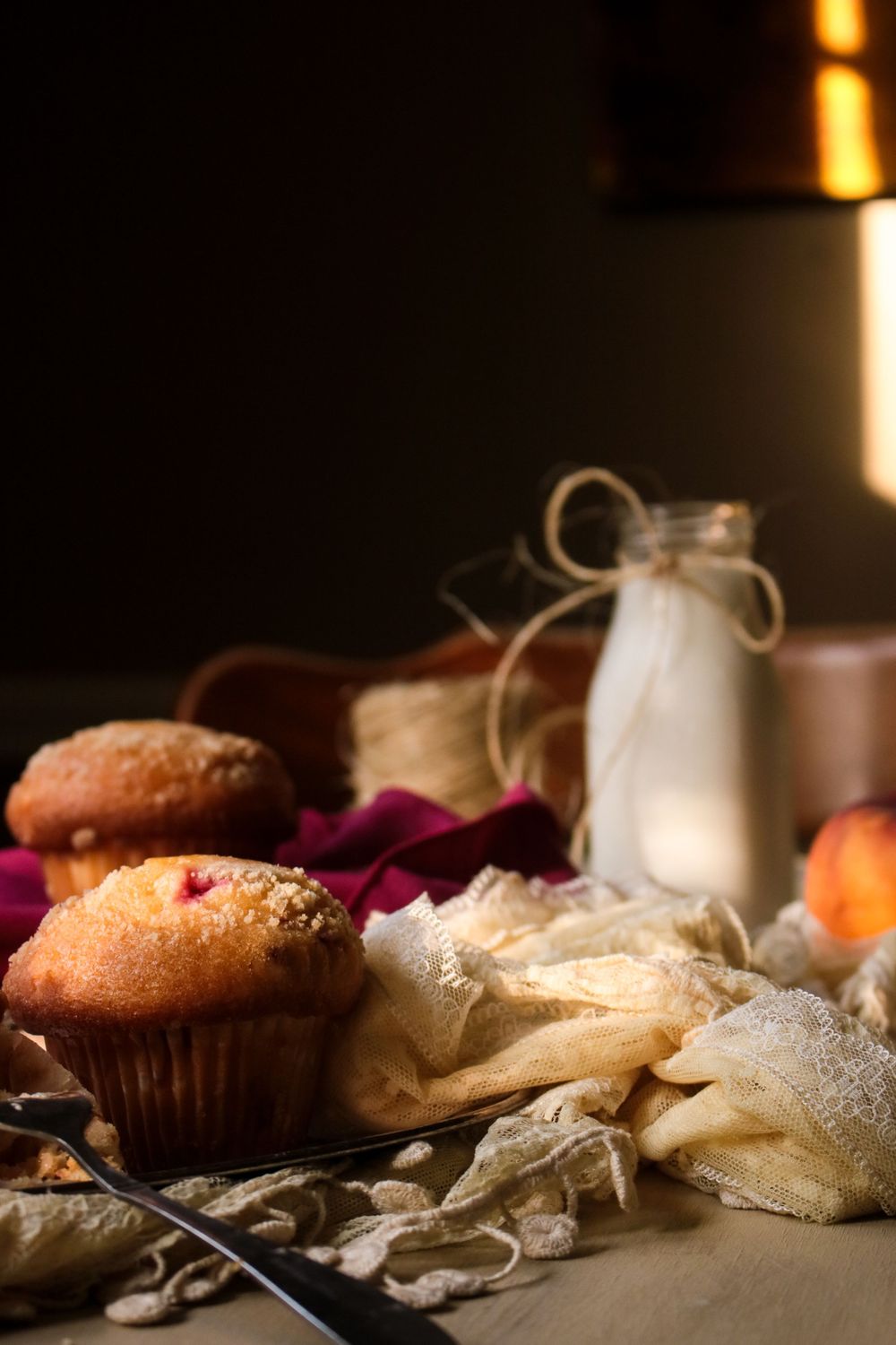 Rustic baked pastries and bread displayed with soft natural lighting.