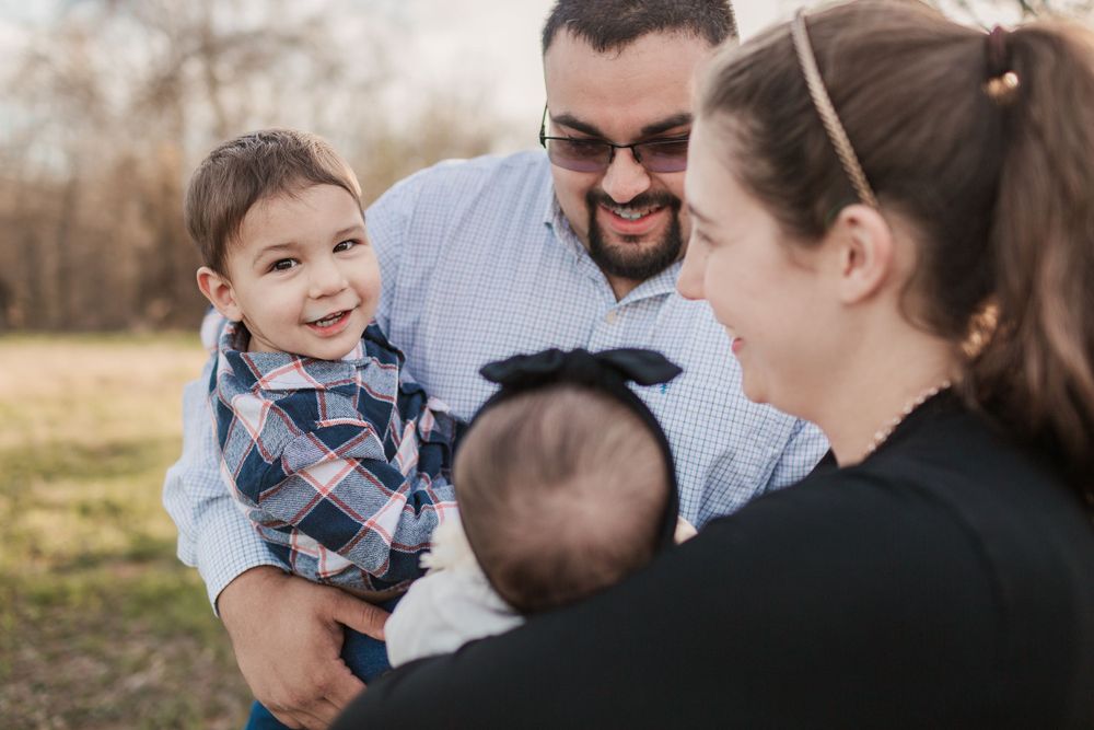 Happy group sharing a joyful moment together outdoors during a family photoshoot.
