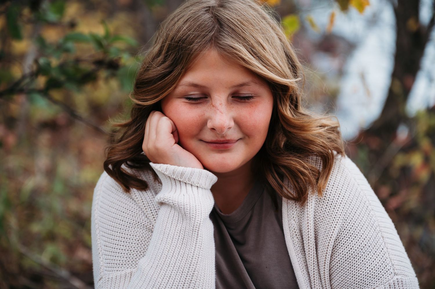 Young girl eyes closed posing for photo session in Orr, Minnesota.