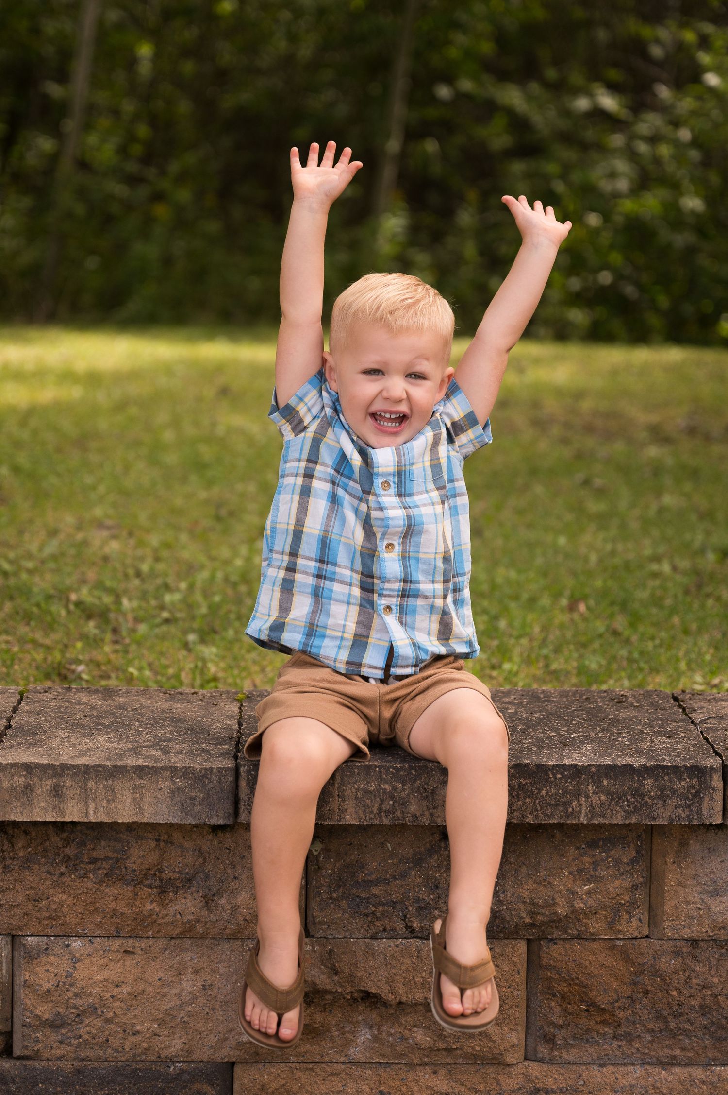 Young boy reaching up for photoshoot in Orr, Minnesota.
