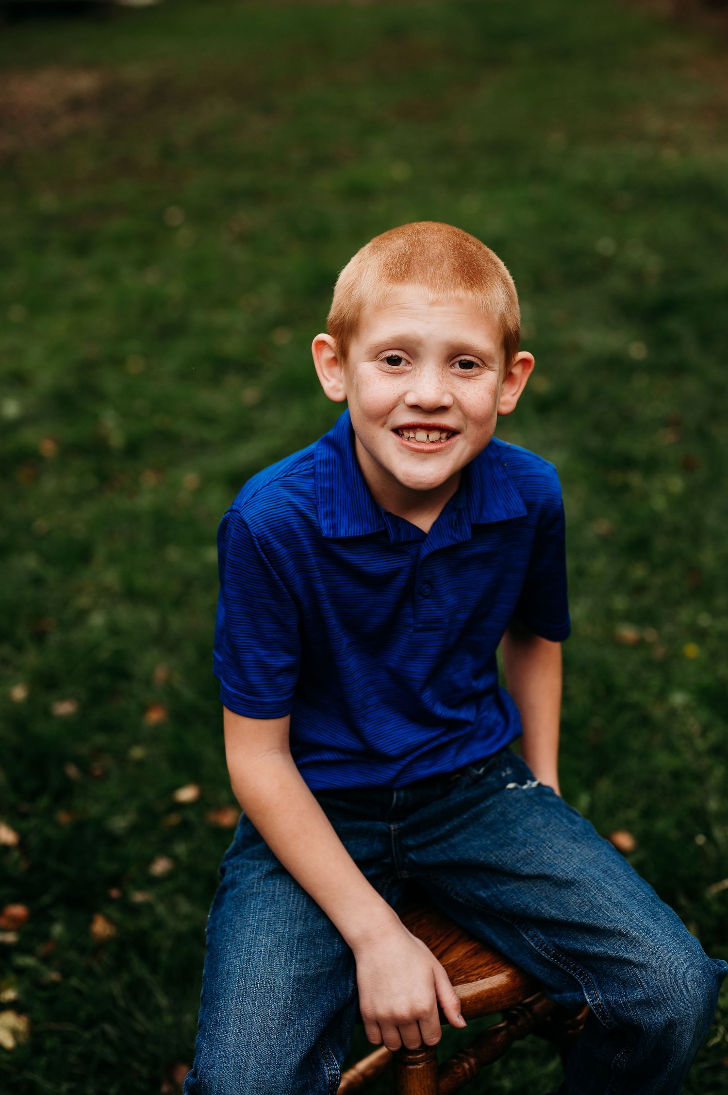 Boy in blue shirt posing for photo session in Orr, Minnesota.