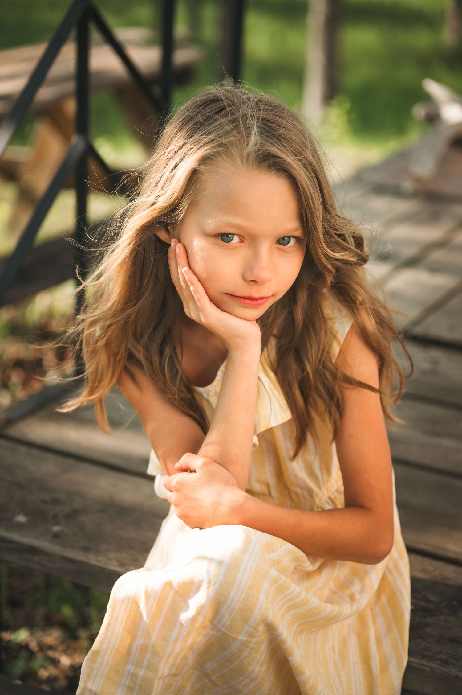 Young girl yellow dress posing in summer scene in Orr, Minnesota.