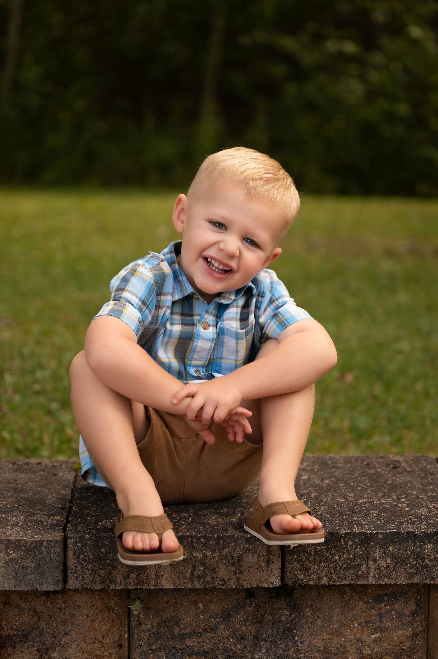 Young boy posing on summer background scene in Orr, Minnesota.
