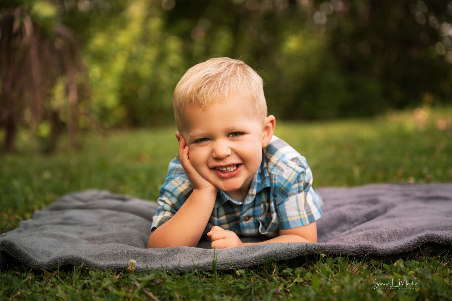 Luka posing on blanket for kids photo session in Orr, Minnesota.