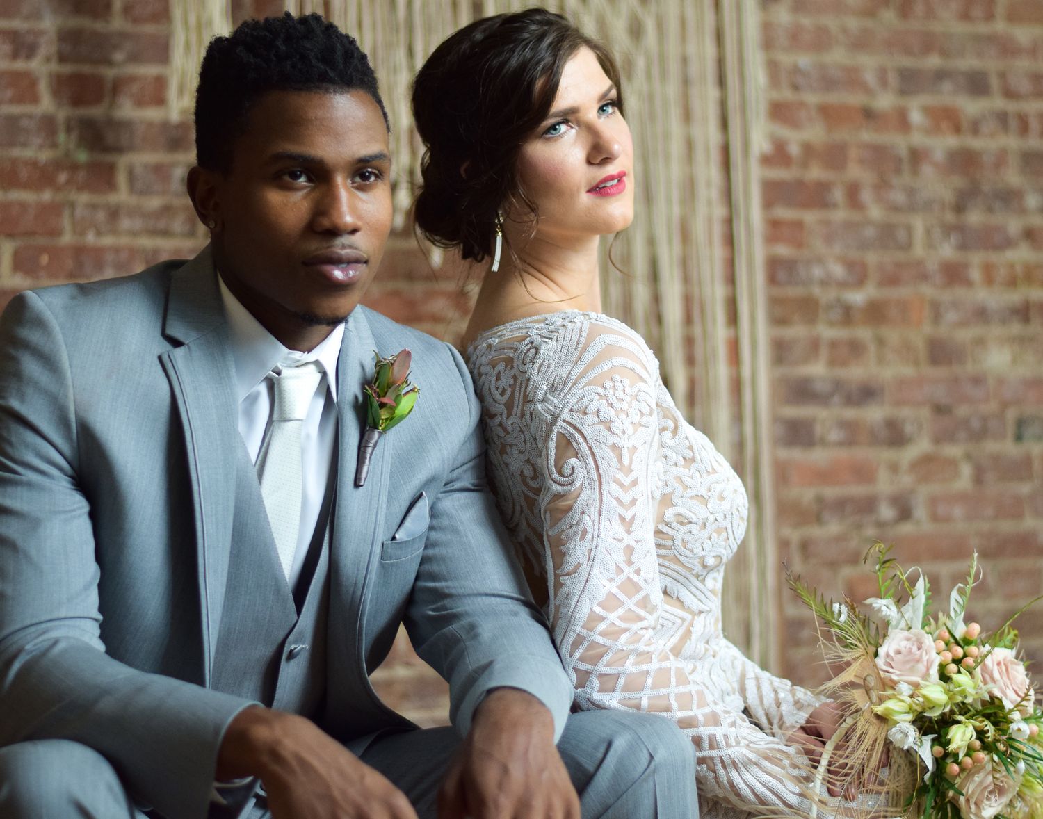 Bride and Groom looking at the camera while sitting down pose