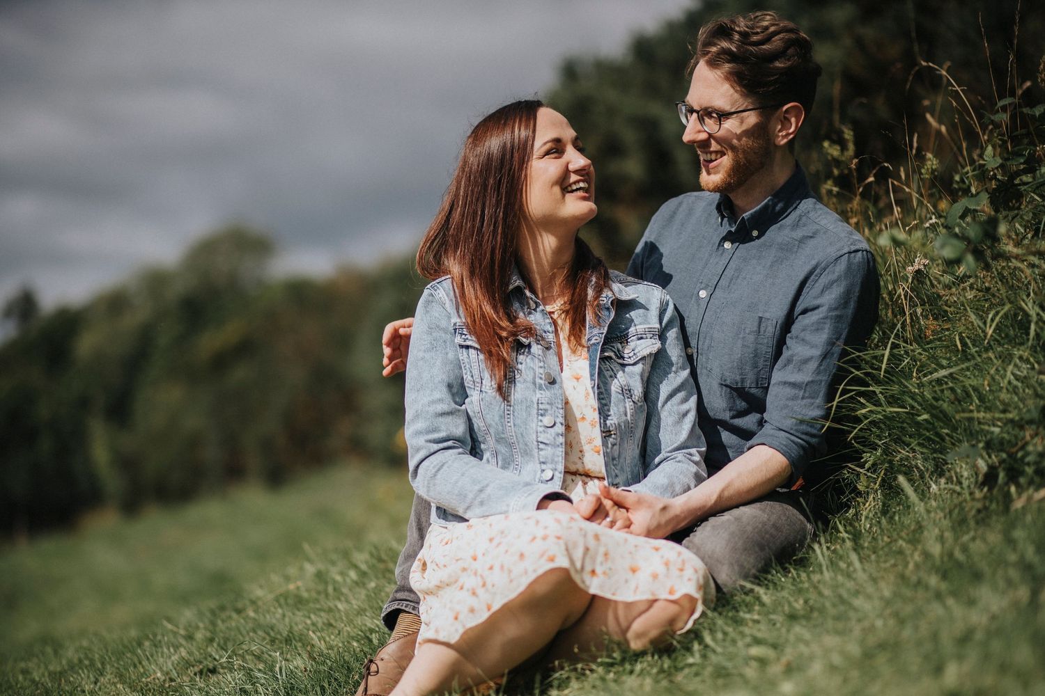 a couple sitting by a river
