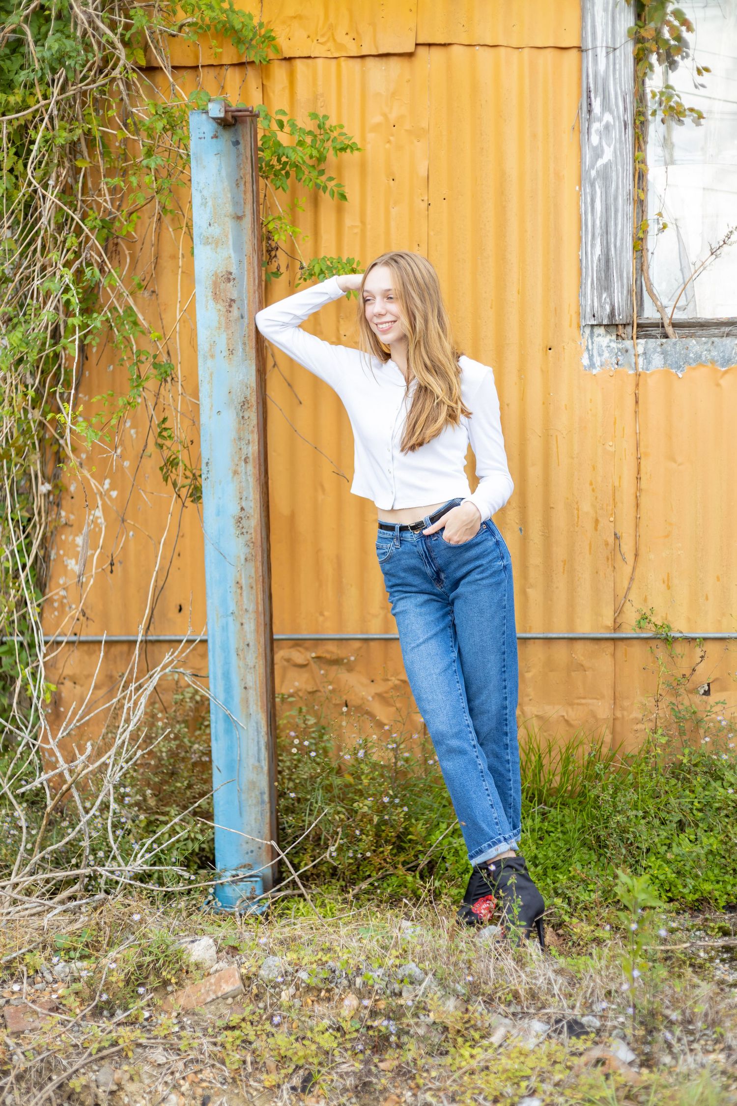 Senior girl by orange wall