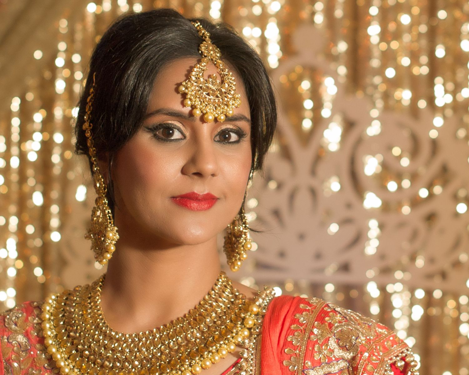 woman from india wears traditional head adornment and dress