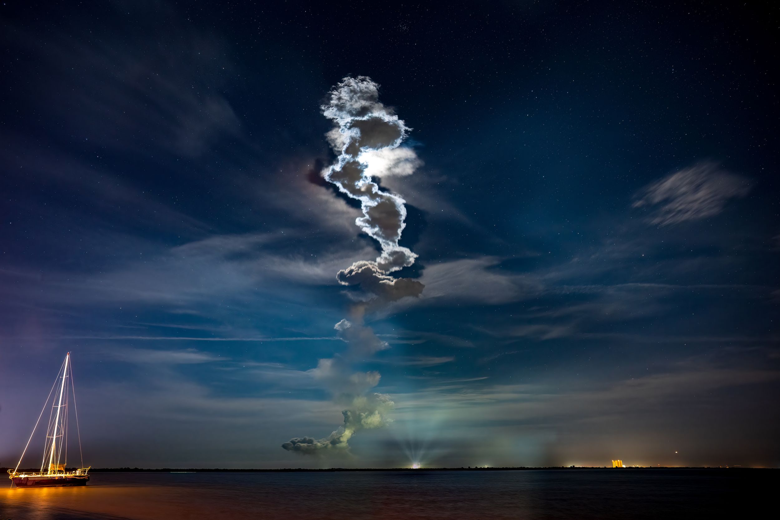Rocket Launch Trail of Artemis Launch, SLS system first flight, at night over water creates a dramatic spiral pattern in the clouds.