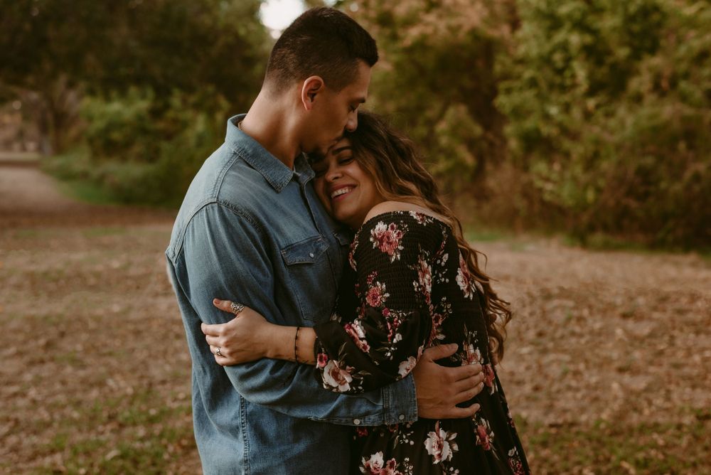 Intimate moment between couple during autumn outdoor photo session.