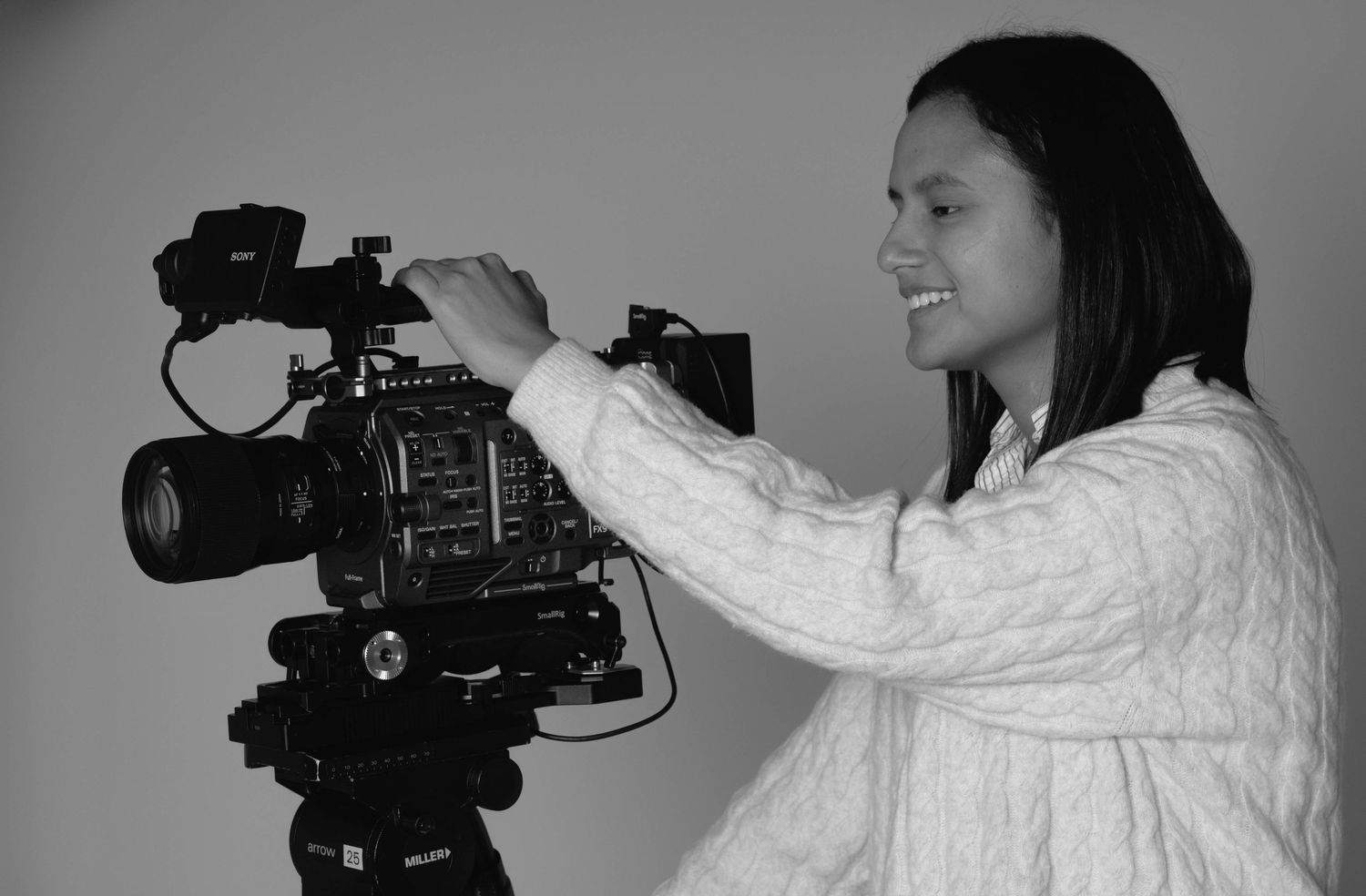 Camila Casas' black and white portait. The artist is in a studio ready to produce a film with the Sony FX9