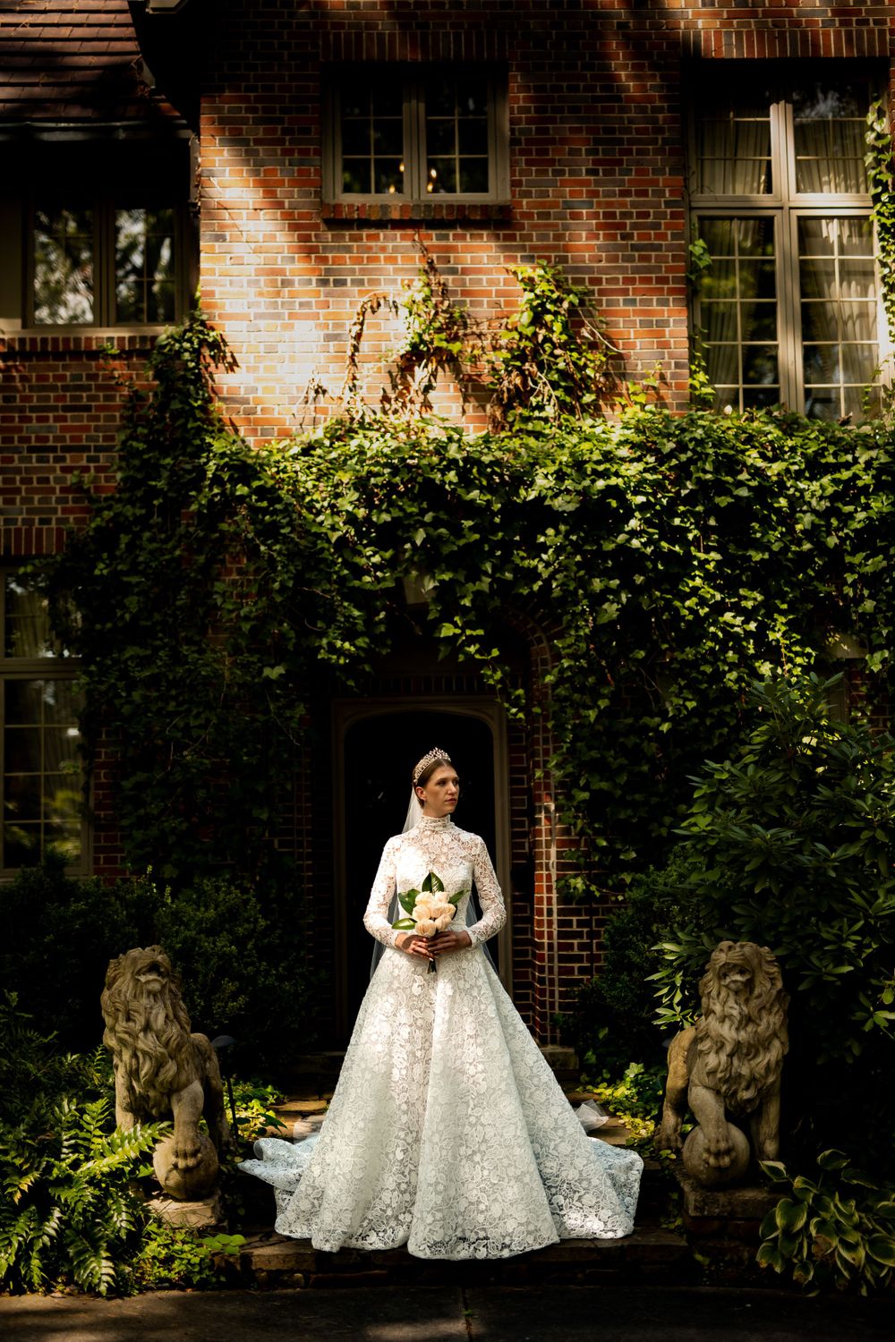 A sweeping wedding dress portrait series against a historic brick building with ivy-covered walls.