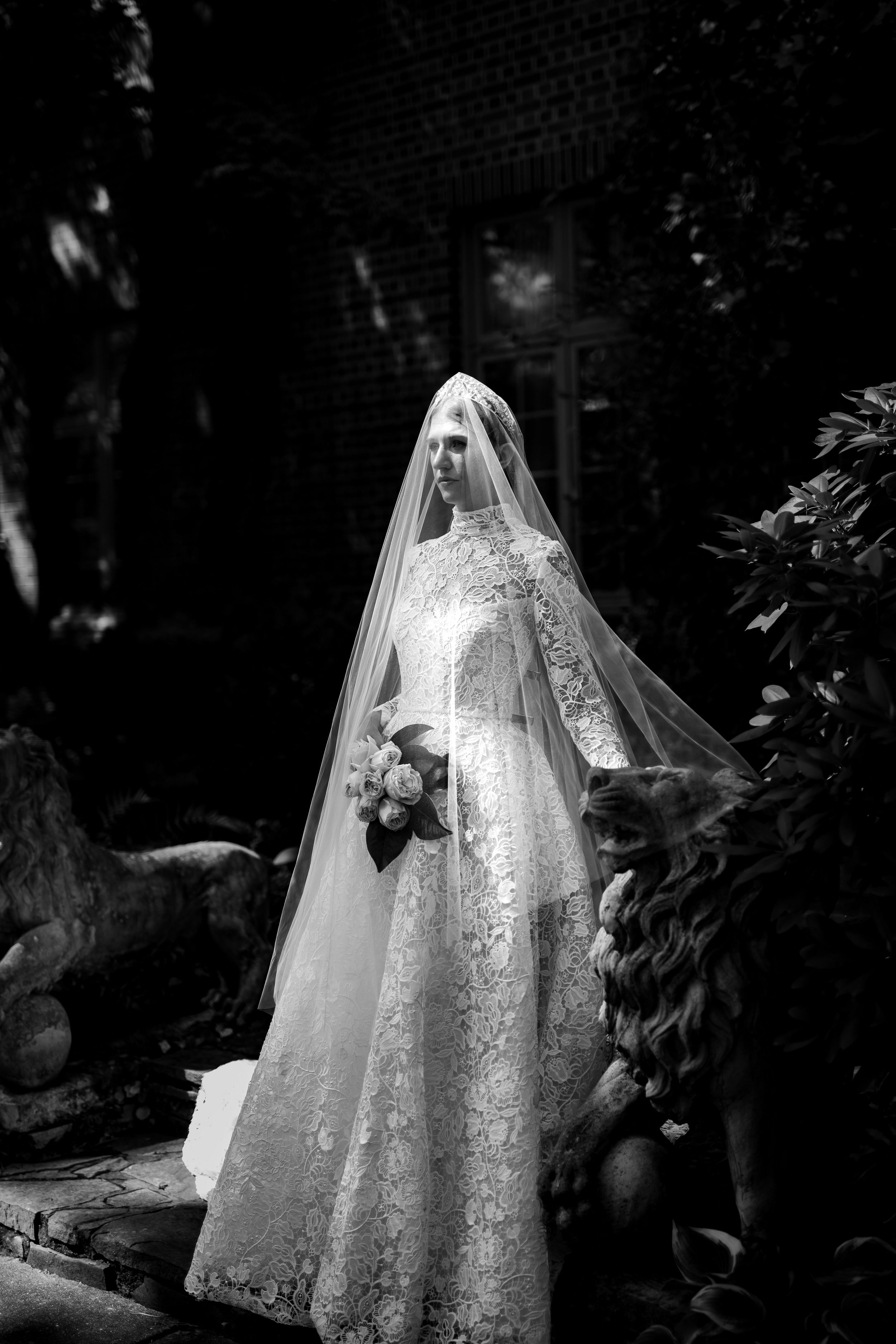 Dramatic black and white bridal portraits showing the intricate details of a lace wedding gown.