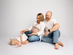 Pregnant mother posing with family in studio maternity session New Hampshire
