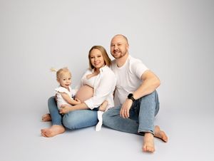 Pregnant mother posing with family in studio maternity session New Hampshire