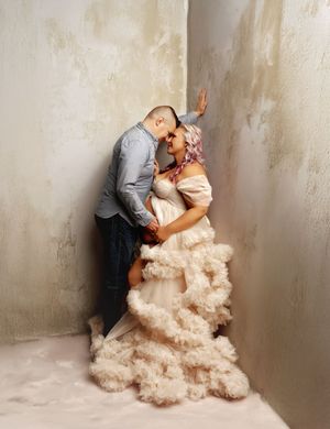 New Hampshire studio maternity photography of an expecting couple, intimate pregnancy portrait with a cream tulle gown and soft fine art