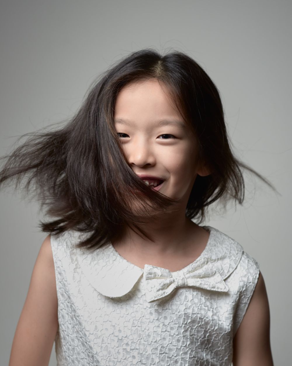 Hester jump turn hair flick headshot Chinese girl birthday photos hyperactive kid fun collaborative game