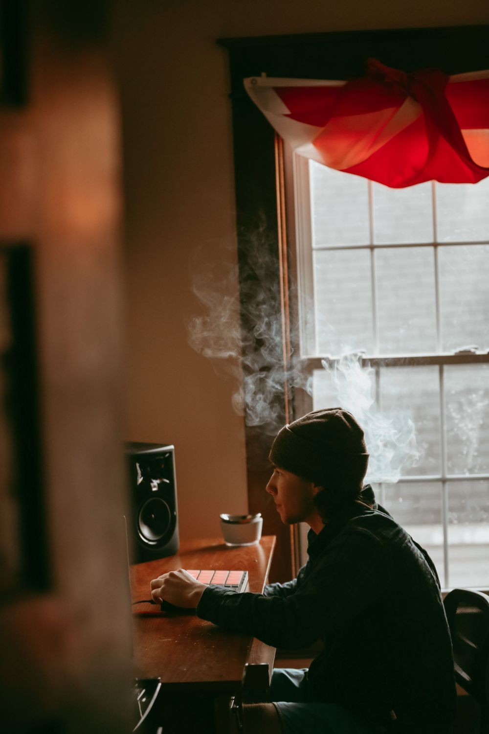 boy making beats in a room with smoke around