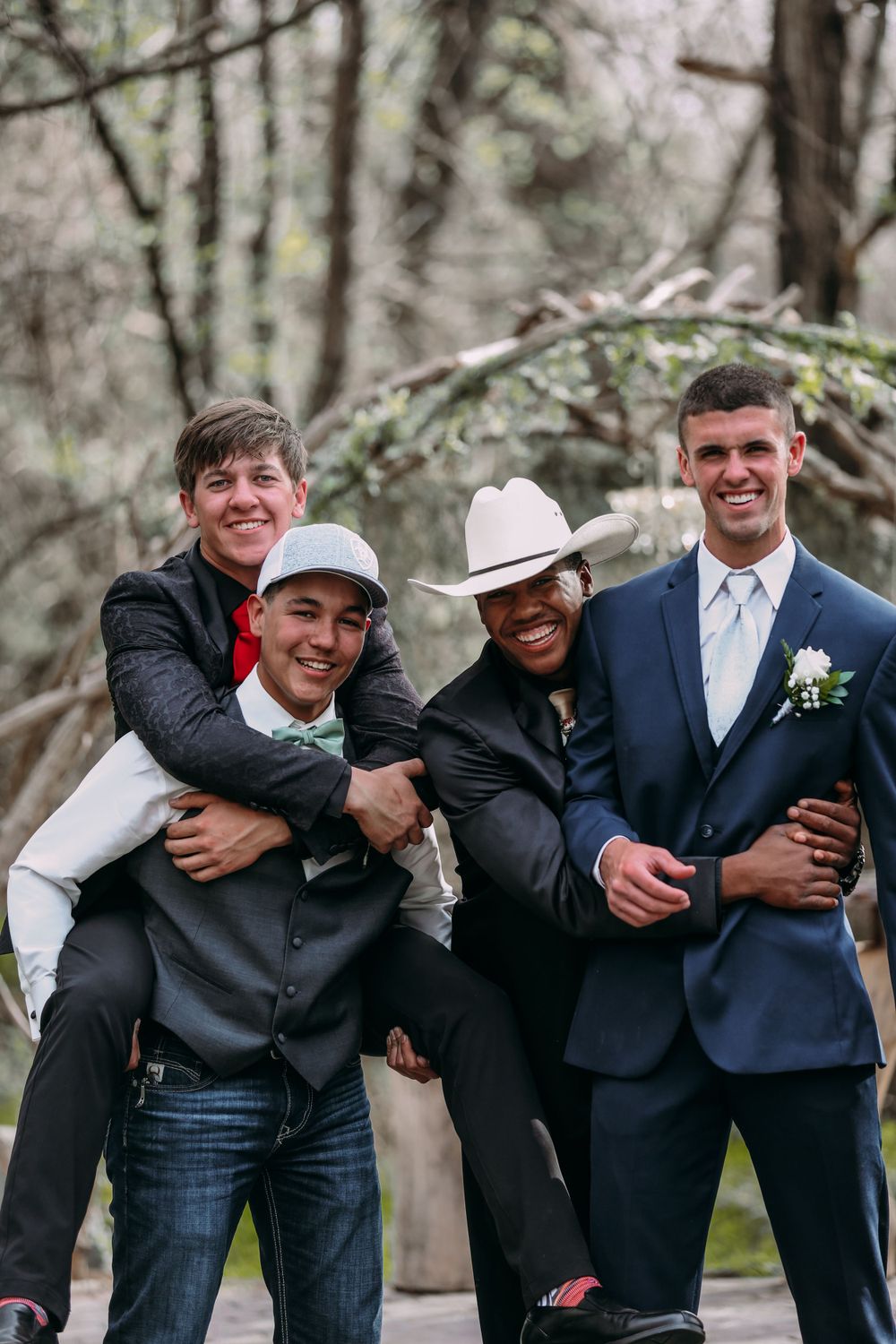 four boys at prom posing