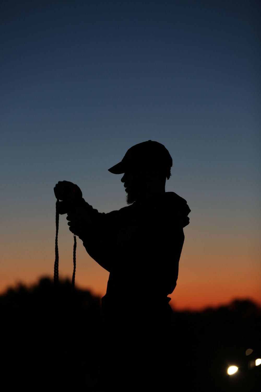 guy holding a camera at sunset
