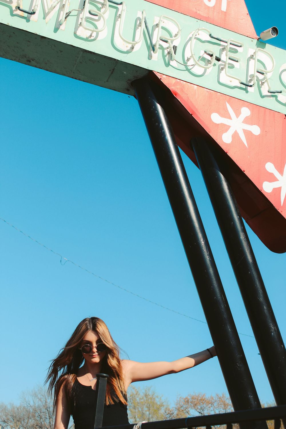 girl hanging on retro sign